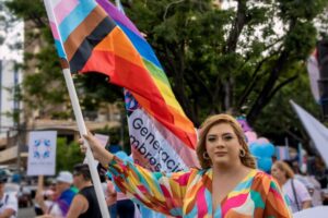 An LGBTQ+ activists waving a pride flag