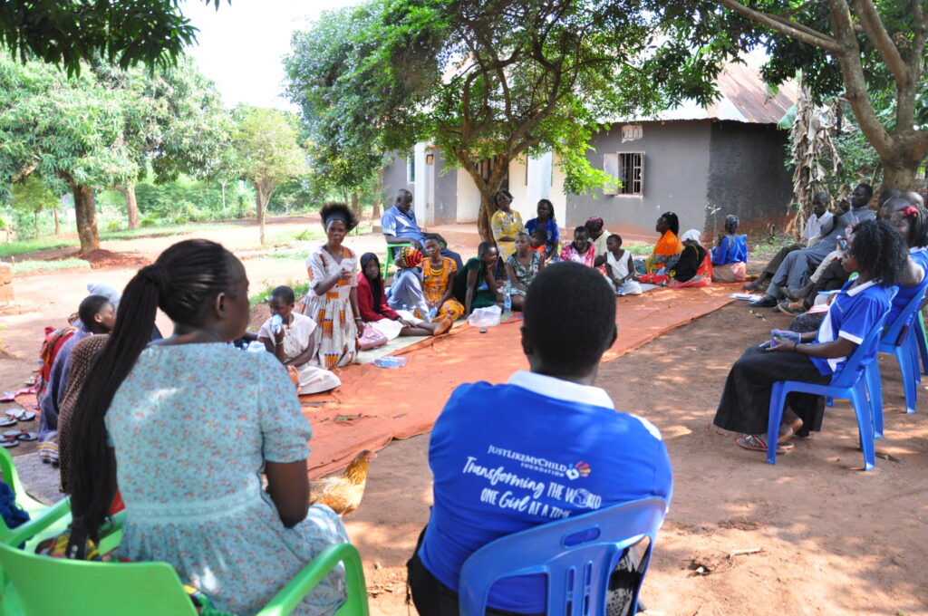 Volunteers facilitating a dialogue in the community in Konde-Bombo Luwero. Topic was on parenting where parents and children sat together and talked about how to get through the holidays safely.